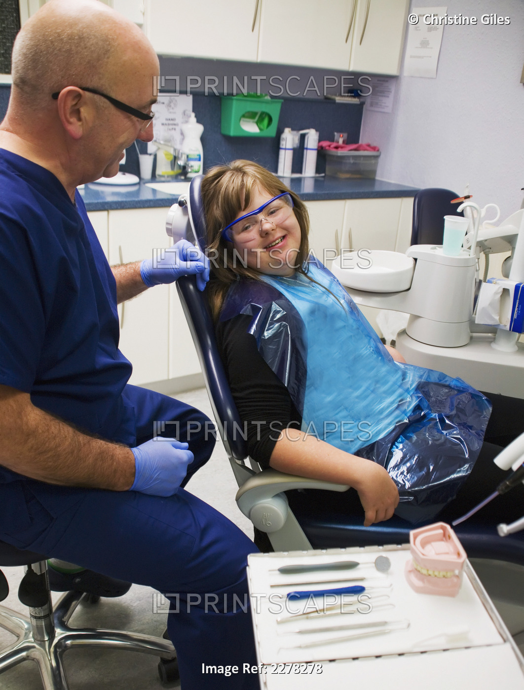 A girl and her dentist during a dental exam; Whitley bay tyne and wear england