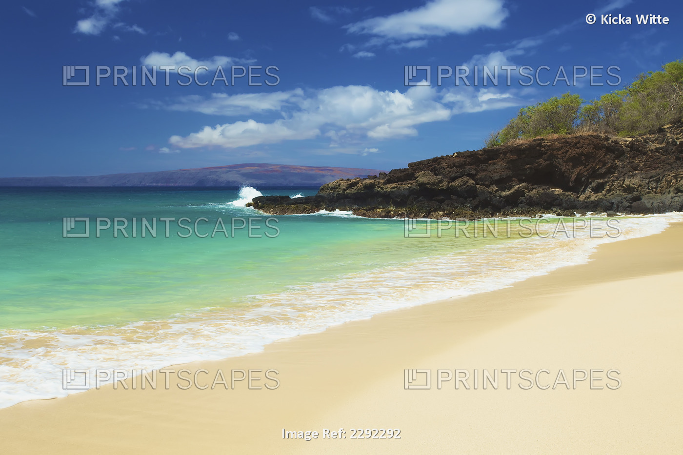 Water washing up on the sandy beach along the coastline of an hawaiian island; ...