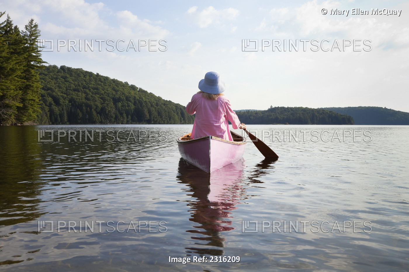 Senior Woman Dressed In Pink And Paddling Her Pink Canoe On Lake In Algonquin ...