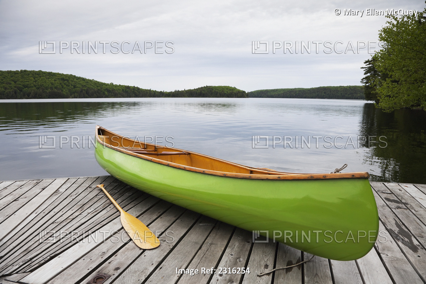 Green Canoe On A Cottage Dock In Algonquin Park; Ontario Canada