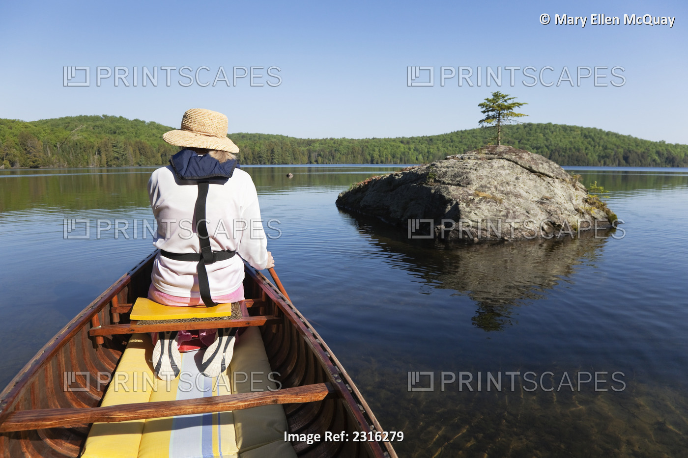 Senior Woman Paddling Her Canoe On A Sunny Morning In Algonquin Park; Ontario ...