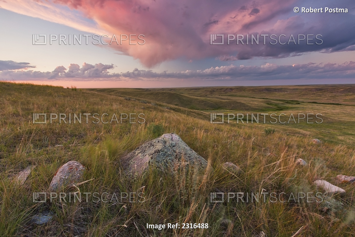 Clouds Lit At Sunset With Some Glacial Erratics Lying In Grasslands National ...