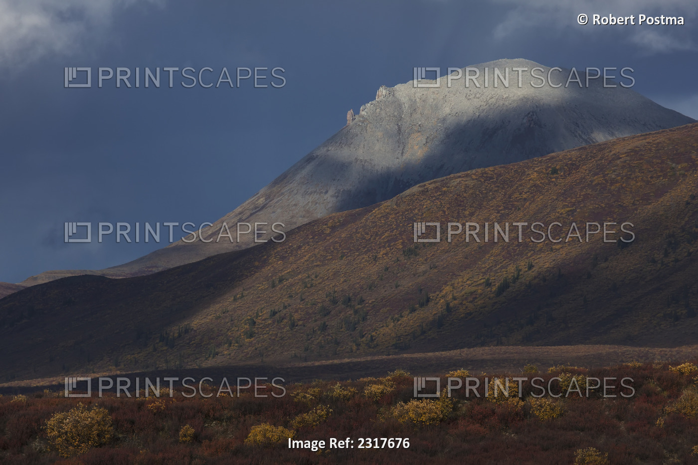 The mountains along the dempster highway are illuminated in dramatic storm ...