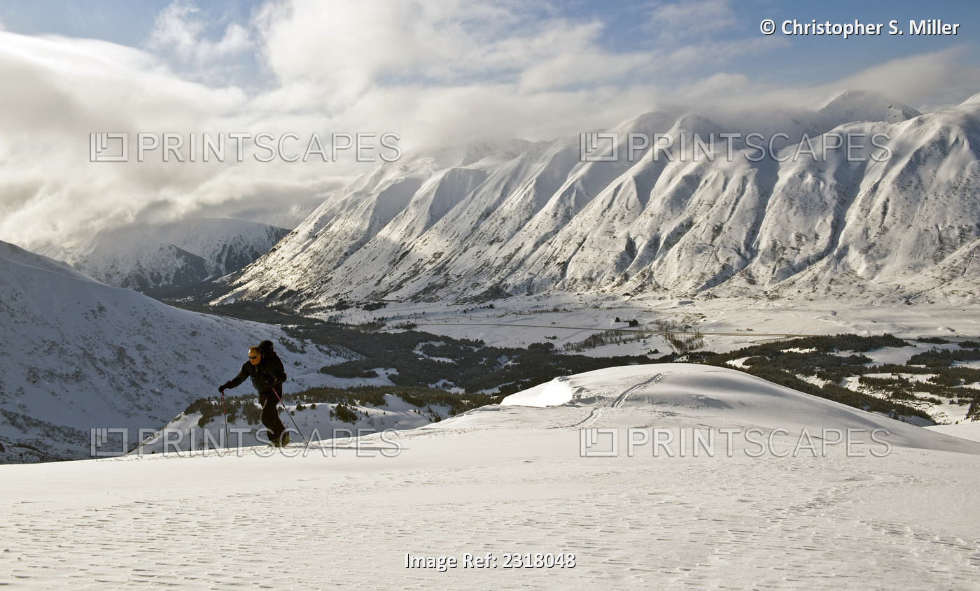 A Backcountry Skier Skinning Up A Ridge In Turnagain Pass, Alaska