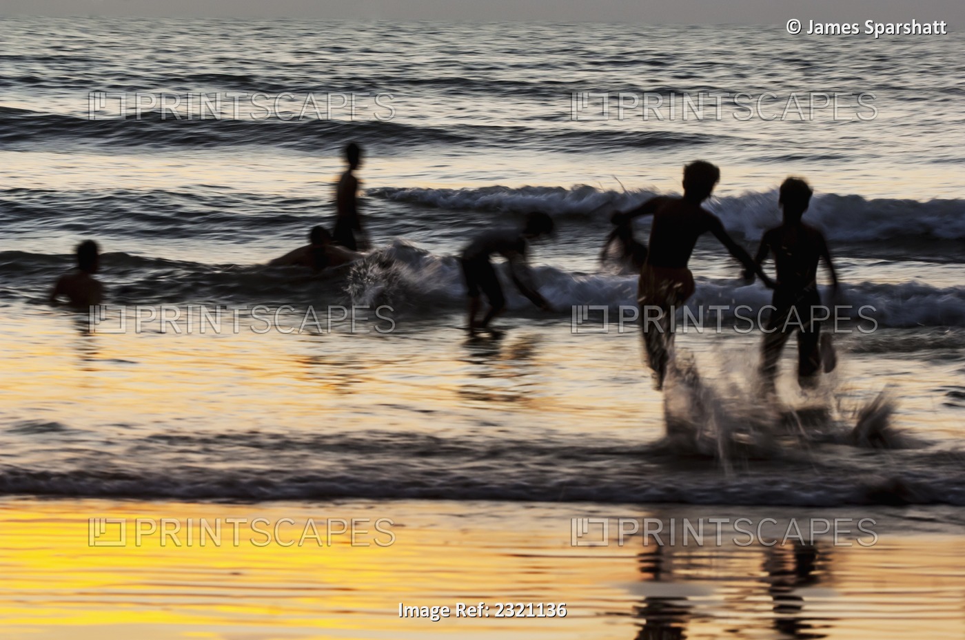 India, Karnataka, Blurry Figures In Crashing Waves At Gokarna Beach; Gokarna
