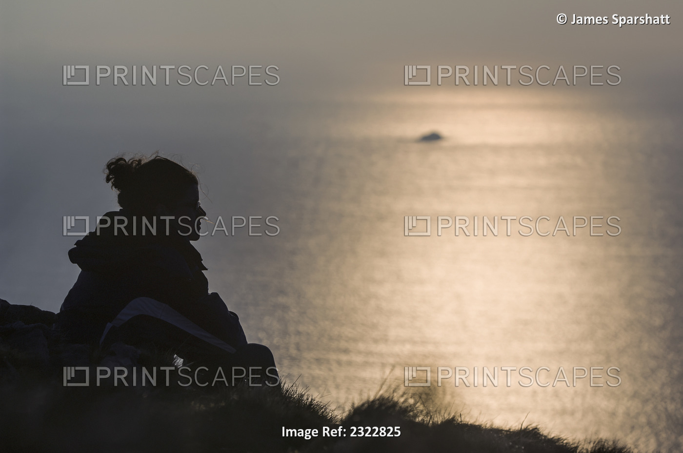Silhouette of woman looking at sea; Skellig Islands, County Kerry, Ireland, UK
