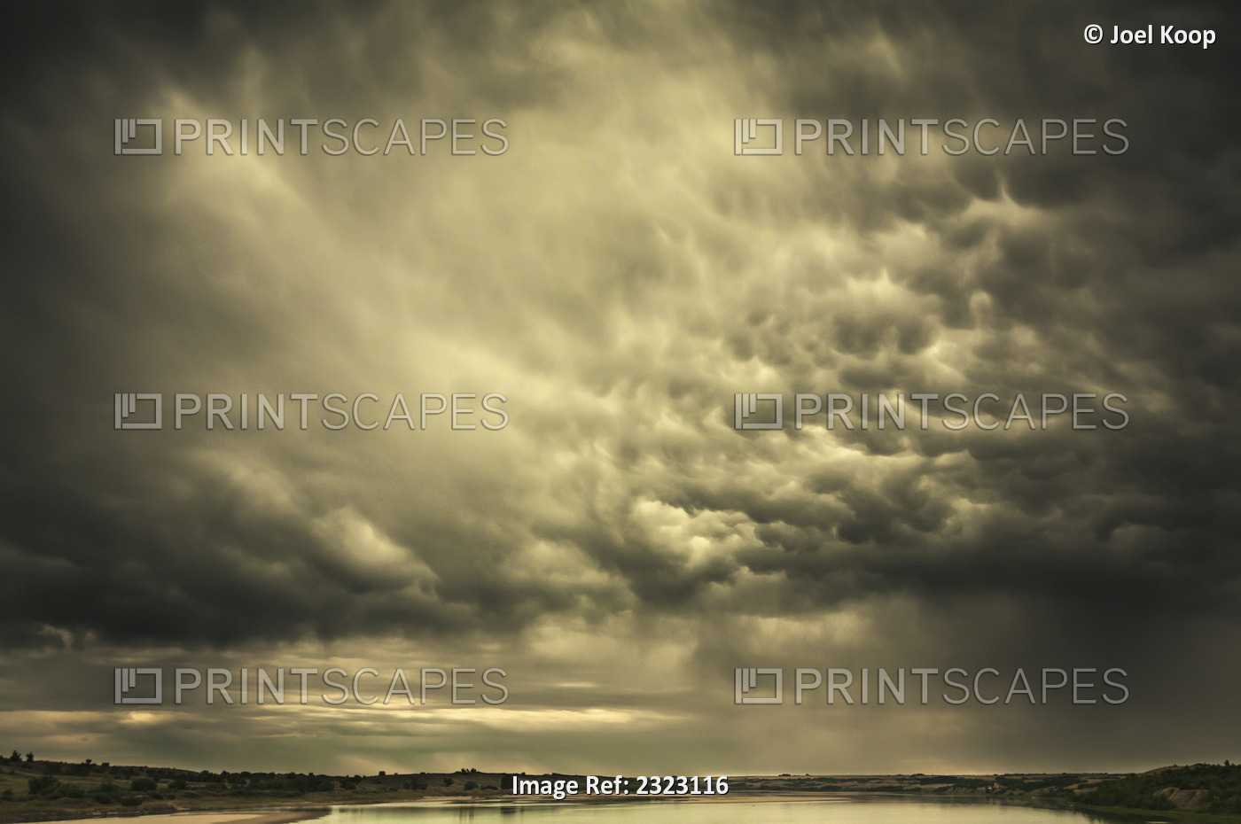 Mammatus storm clouds above a lake in the saskatchewan prairies;Saskatchewan, ...