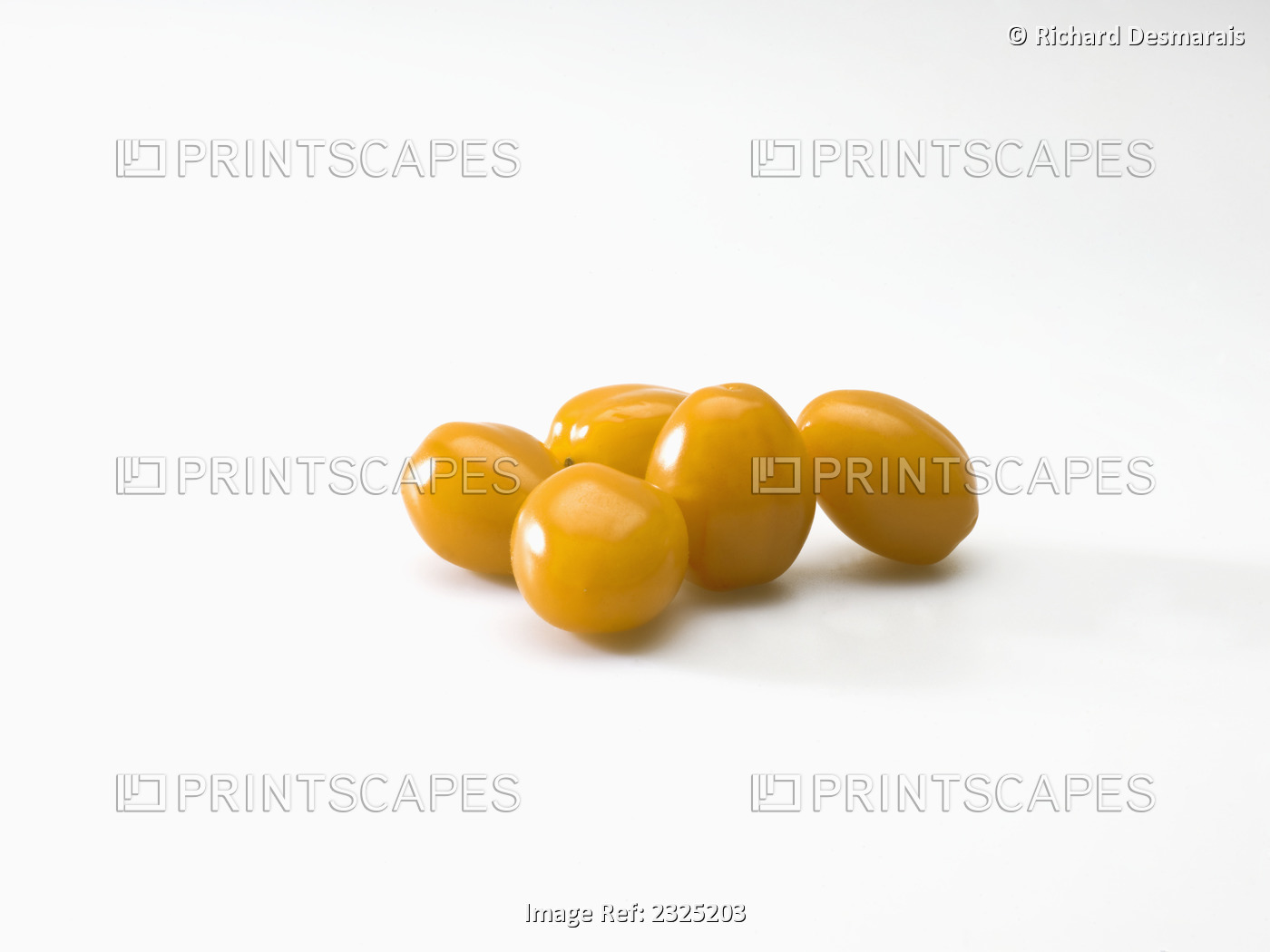 Yellow plum tomatoes on a white background
