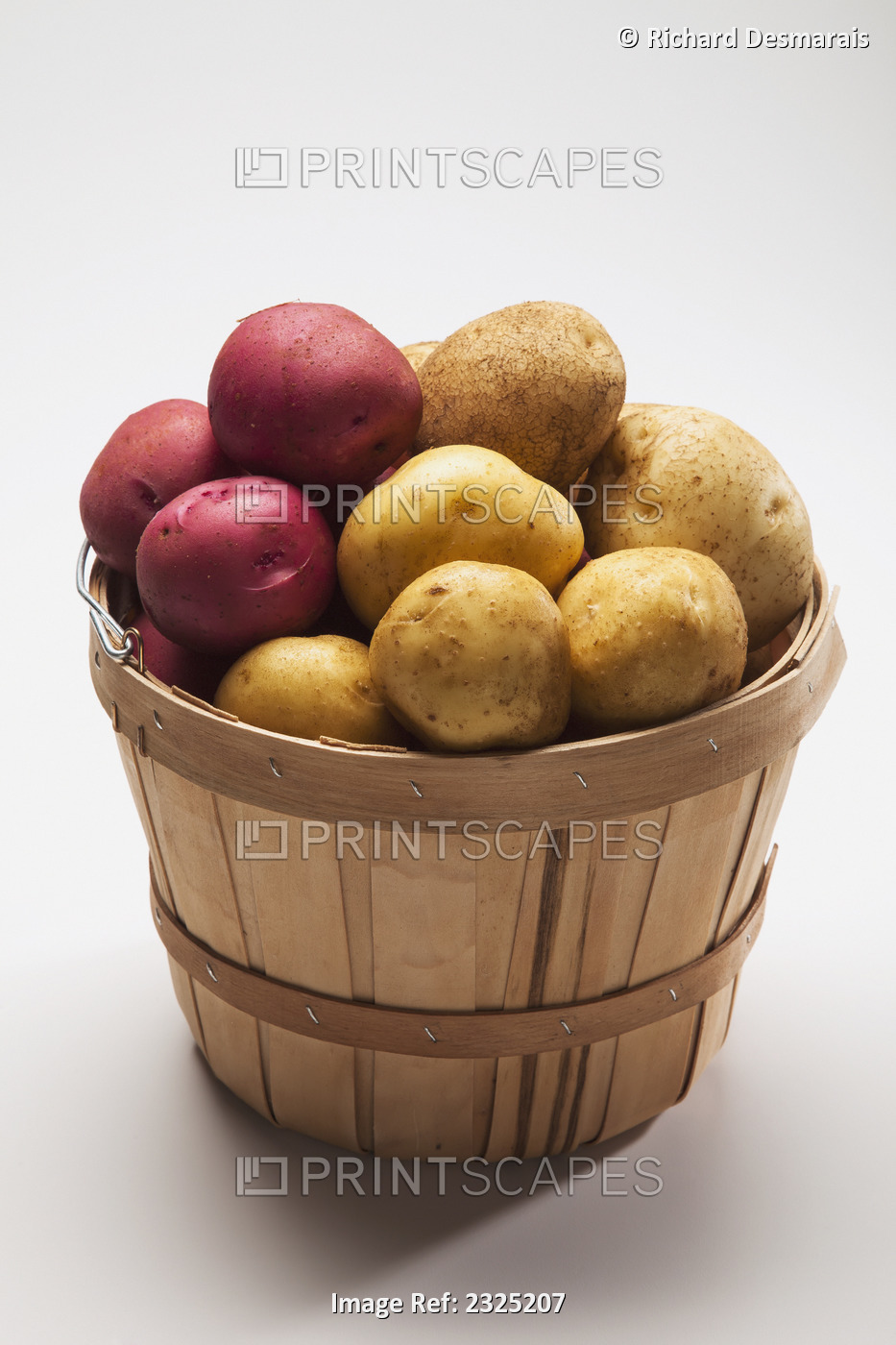 A basket full of white and red potatoes