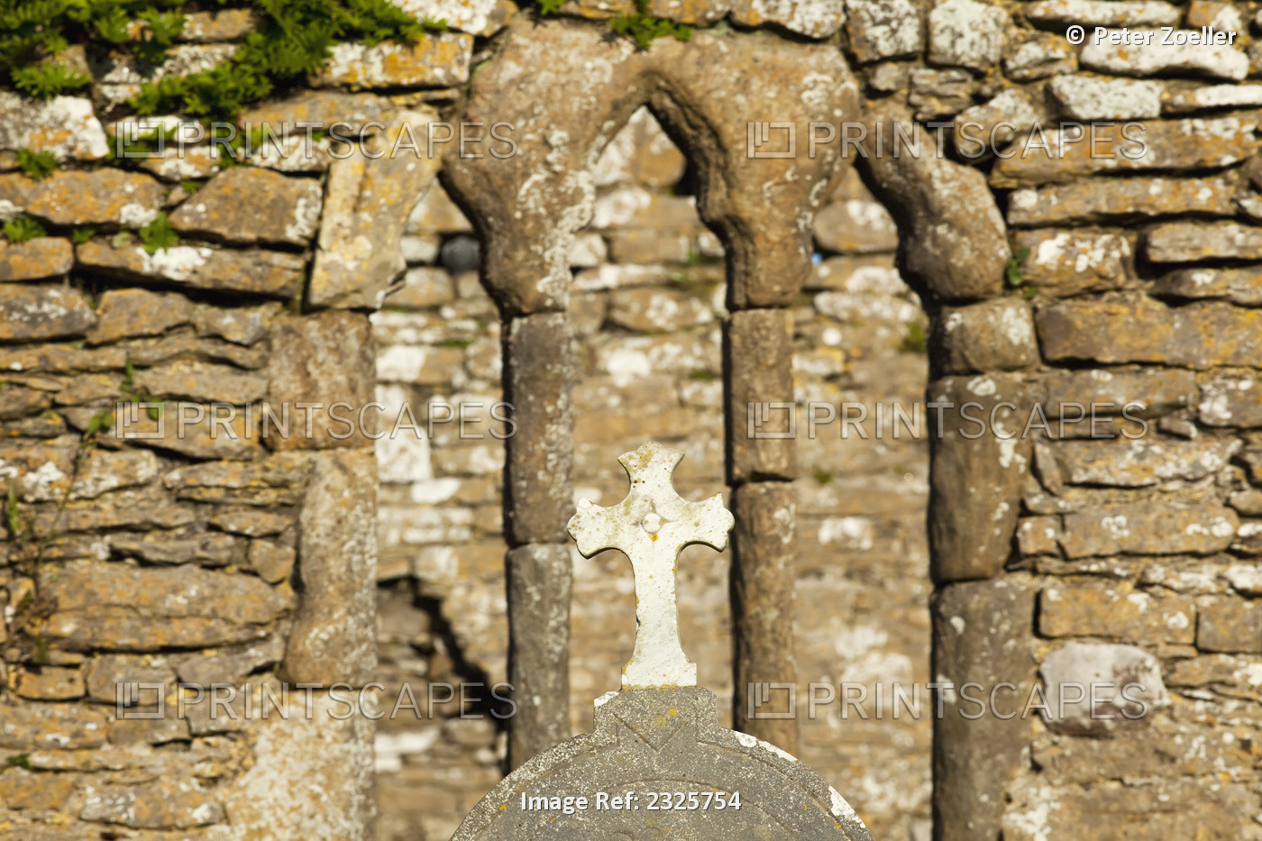 Stone wall and cross of an old church at hook head; County wexford, ireland