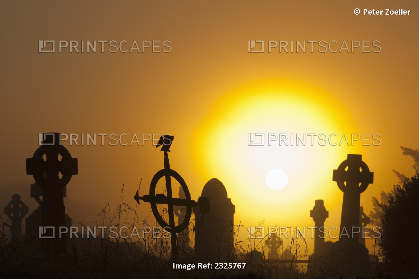 Sunrise at aghadoe heights graveyard with silhouetted tombstones;Killarney, ...