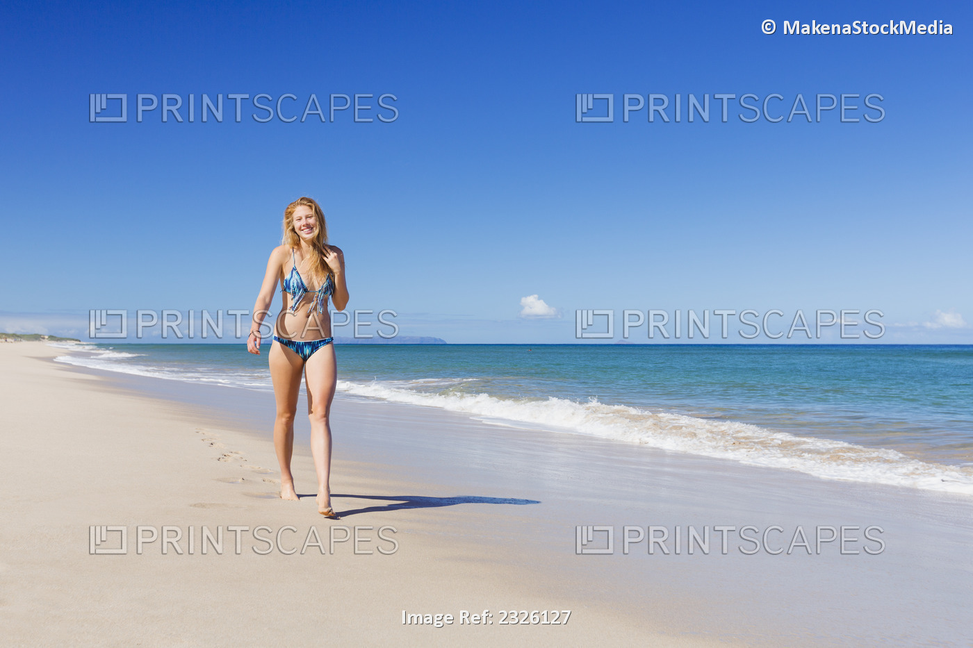 Woman walking on polihale beach; Kauai, hawaii, united states of america