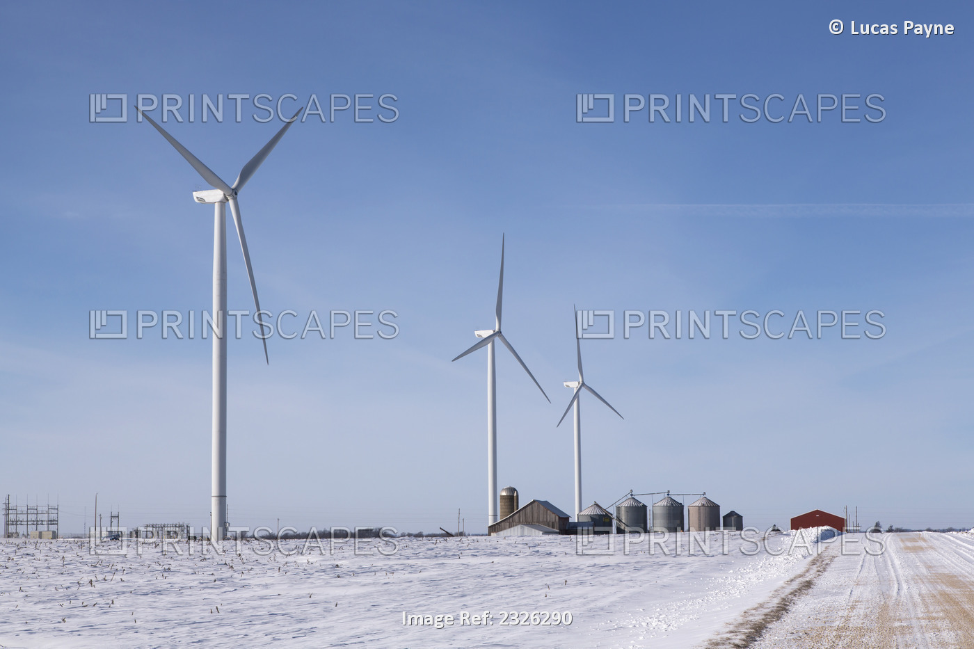 Wind turbines from the Elk Wind Energy Farm and a snow covered landscape near ...