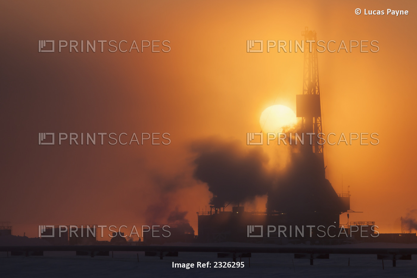 Doyon Drilling Rig and well houses on Drill Site 7 at sunset in the Prudhoe Bay ...