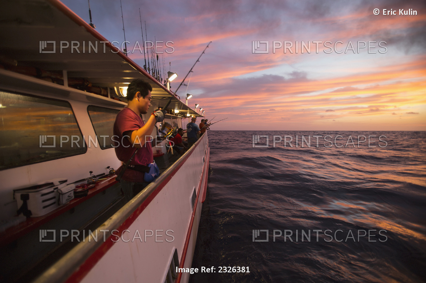 Man fishing at dusk off of boat; Corpus christi texas usa