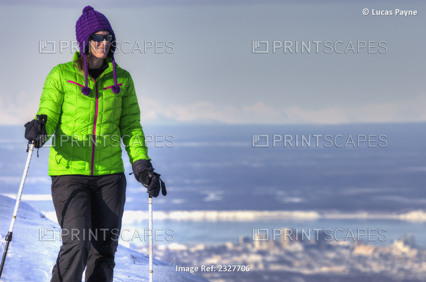 Woman snowshoer taking in the view from Blueberry Hill at the Glen Alps area of ...