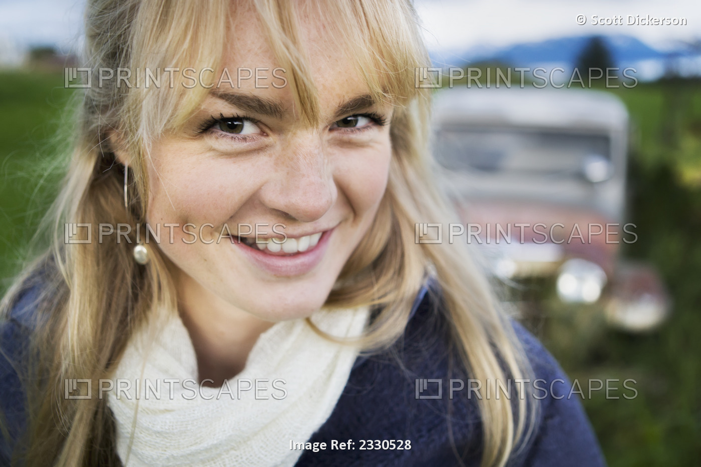 Portrait Of A Teenage Girl With A Vintage Car In The Background; Homer, Alaska, ...