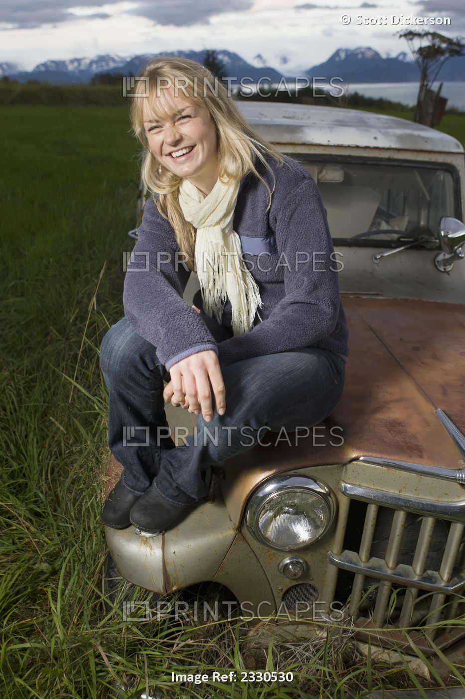 Portrait Of A Teenage Girl Sitting On A Vintage Car With Mountains In The ...