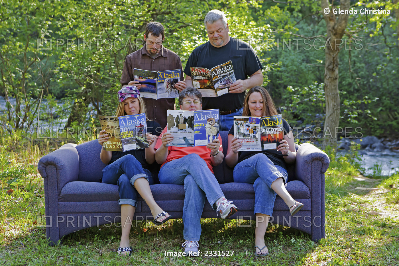 Family On Outdoor Couch Reading Alaska Magazine In Hatcher Pass, Southcentral ...