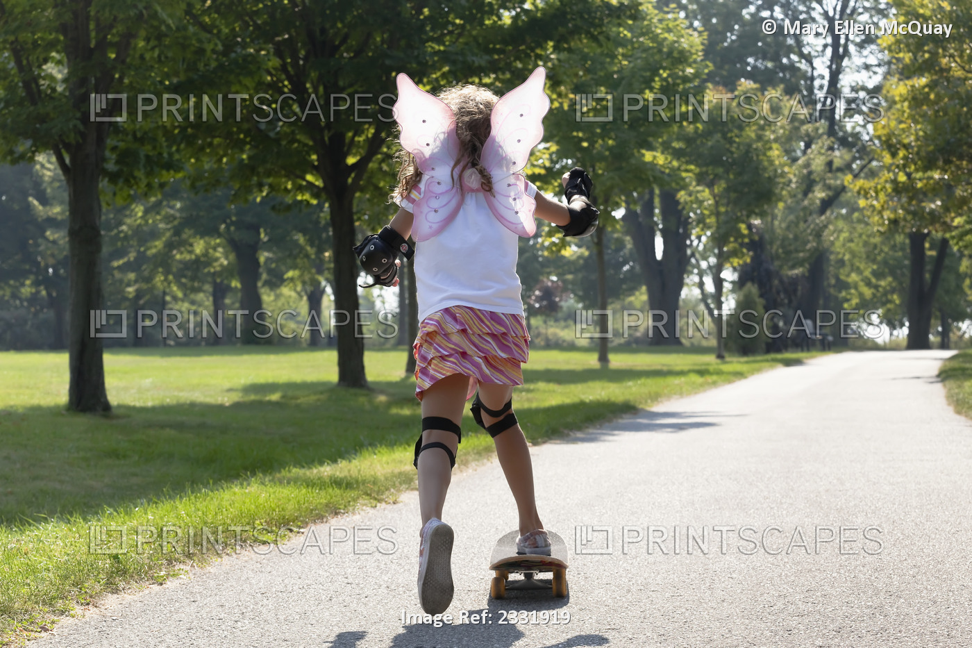 Young Girl Skateboarding While Wearing Fairy Wings;Whitby Ontario Canada