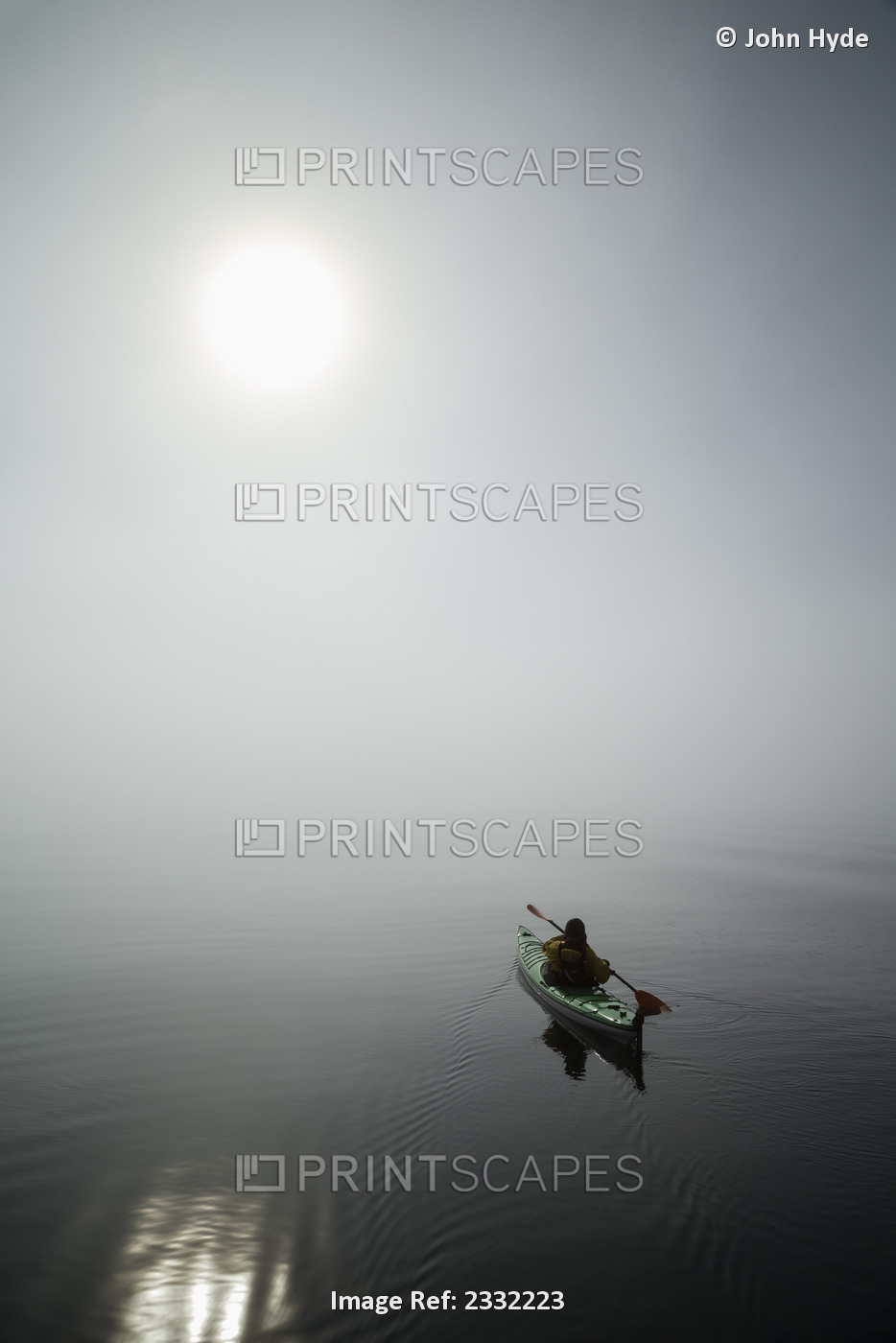 A Sea Kayaker Paddles Into Thick Fog On On A Calm Morning In Southeast Alaska's ...