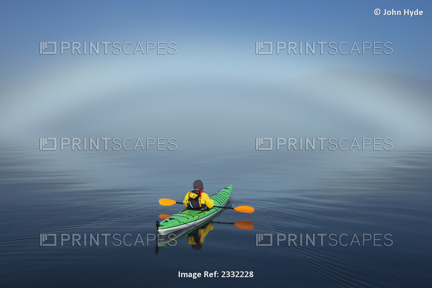 A Sea Kayaker Paddles Along The Edge Of A Thick Fog Bank In Southeast Alaska's ...