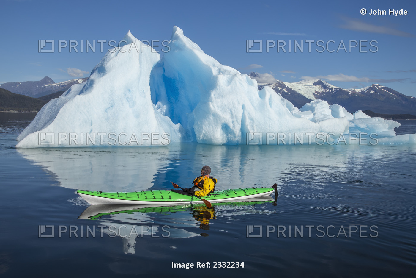 A Sea Kayaker Paddles Beside An Iceberg In Southeast Alaska's Stephens Passage ...