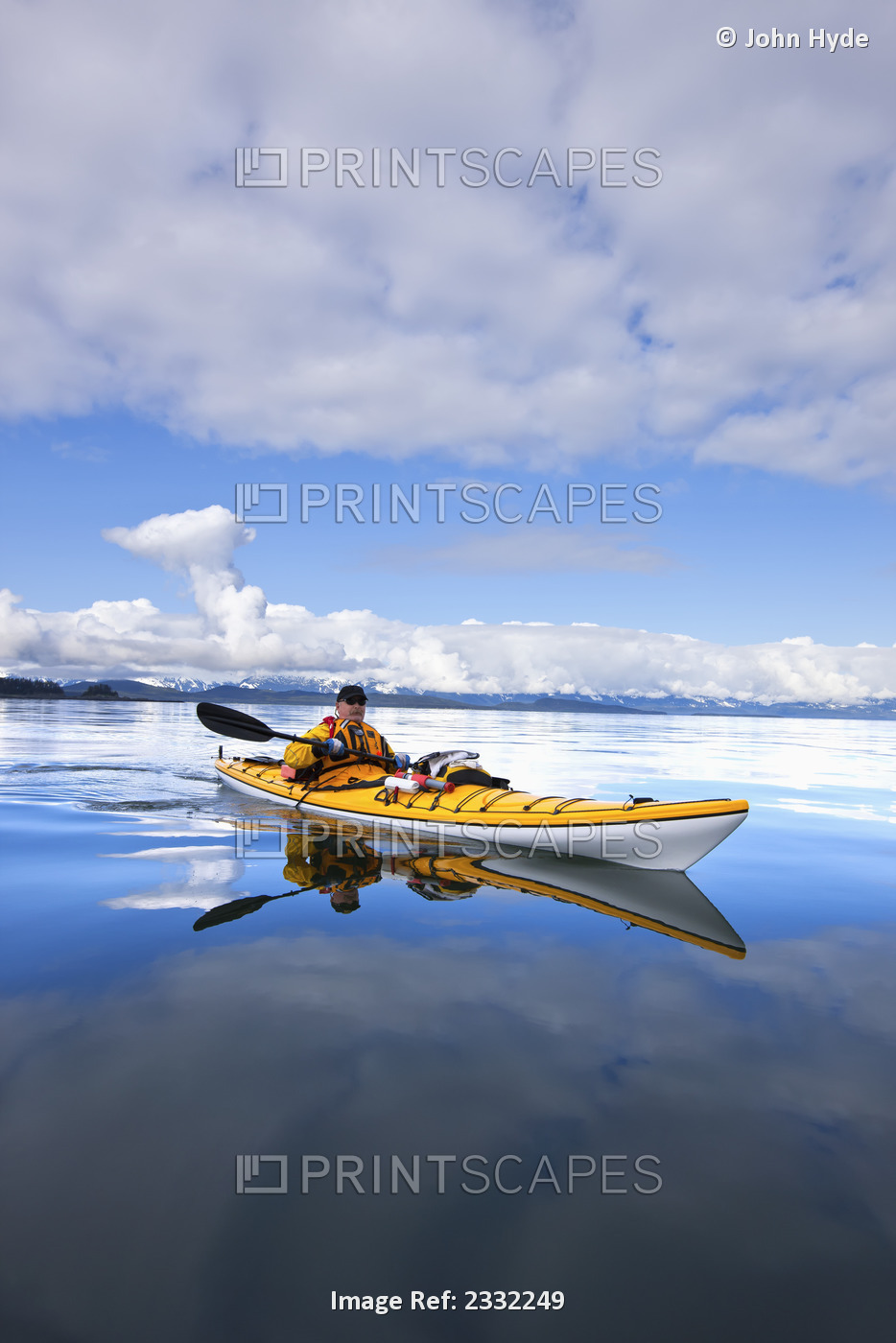 A Kayaker Enjoys A Tranquil Morning Paddle In Lynn Canal, Alaska, Near Juneau. ...