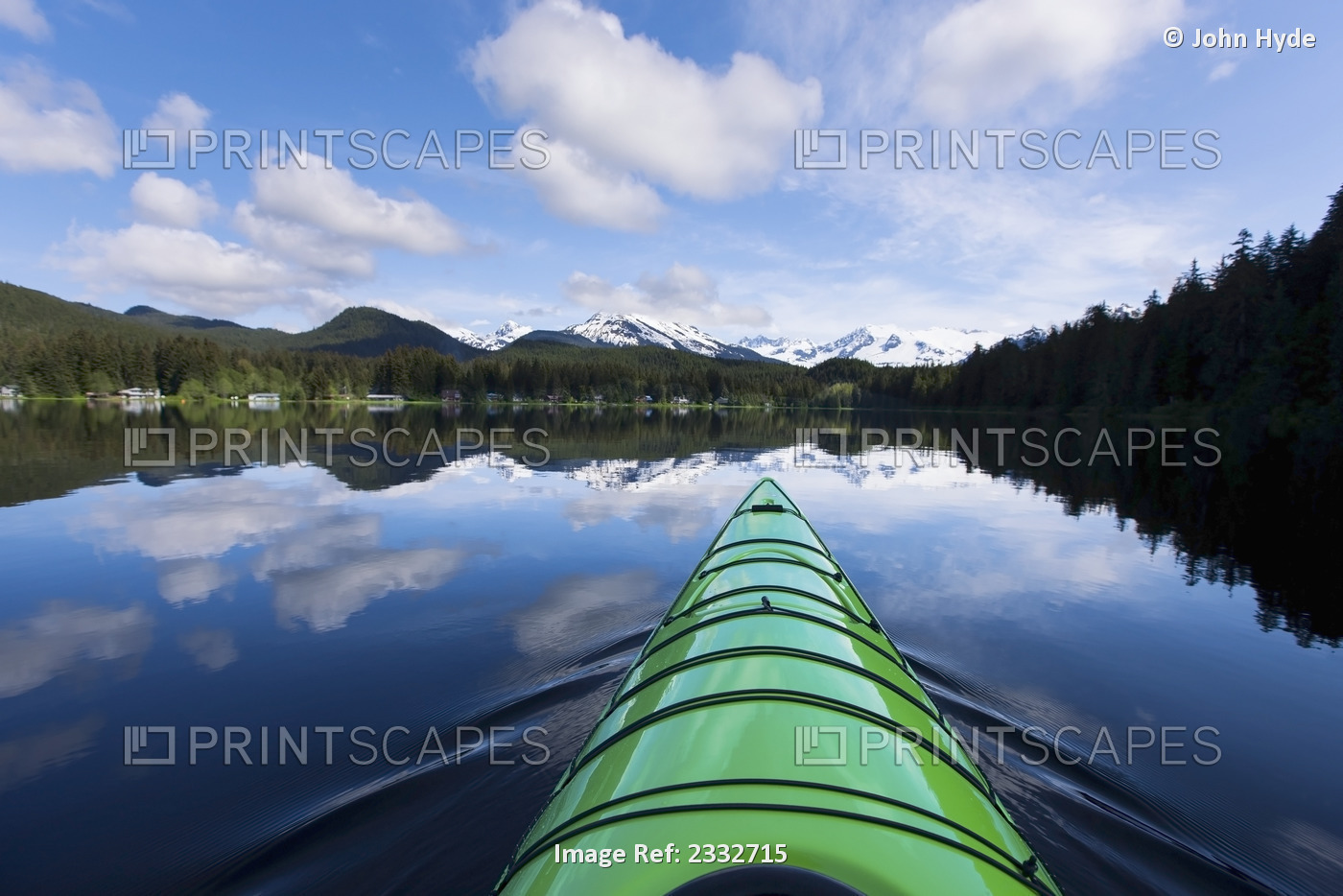 A kayaker enjoys a tranquil morning paddle on Auke Lake, Alaska, near Juneau. ...