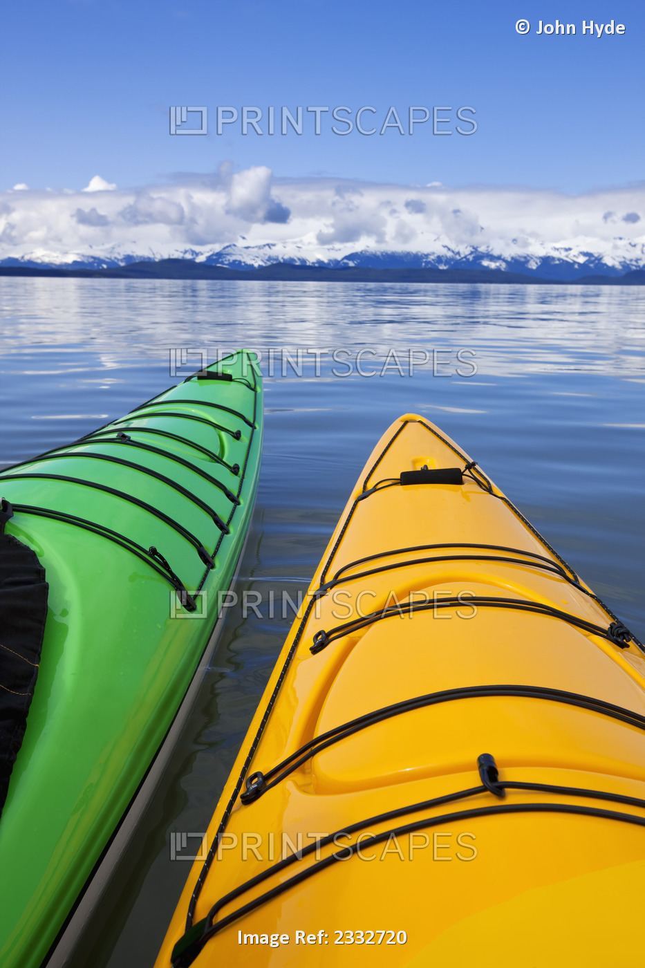 Kayakers enjoy a tranquil morning paddle in Lynn Canal, Alaska, near Juneau. ...