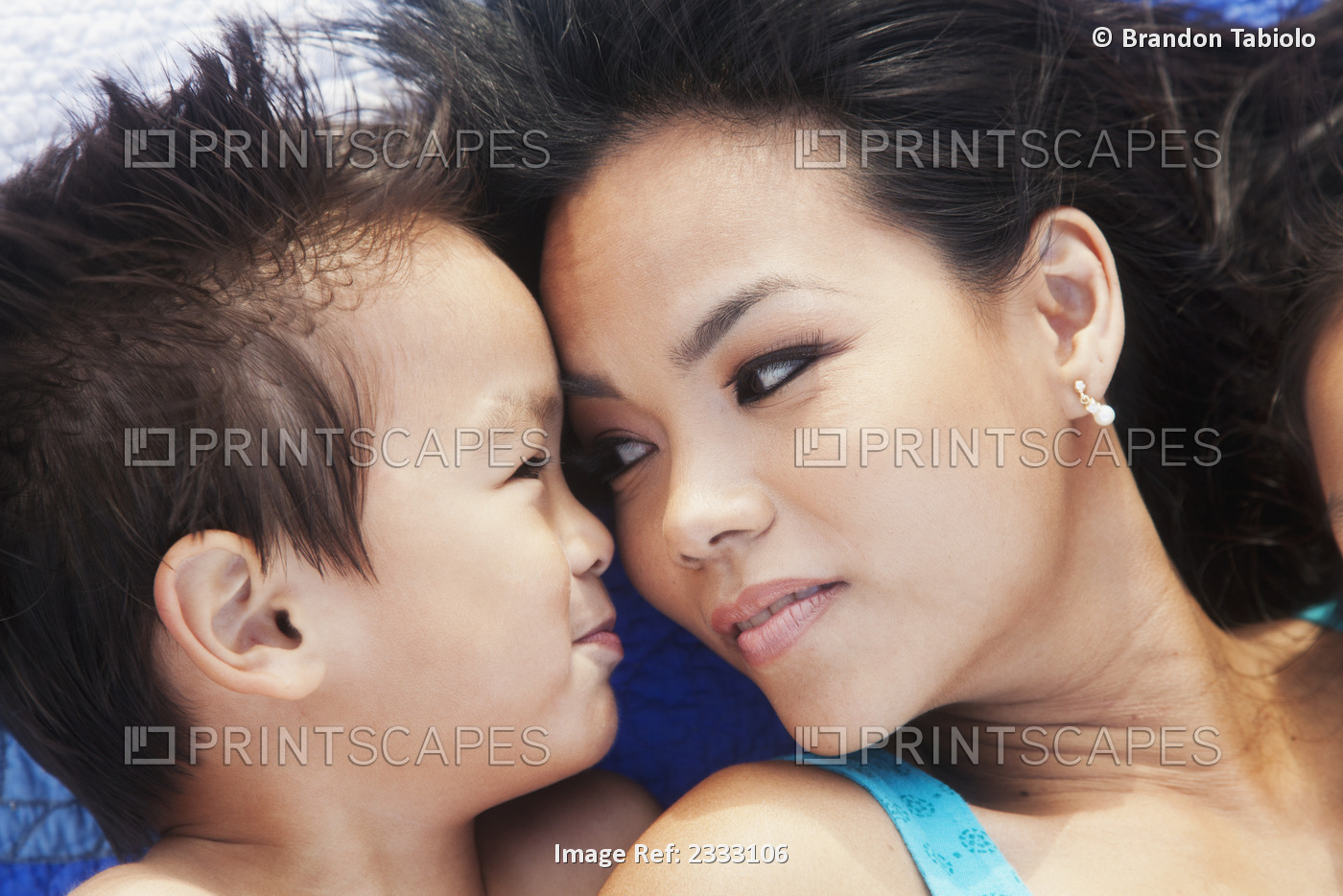 A mother and her young son laying face to face; Honolulu oahu hawaii united ...