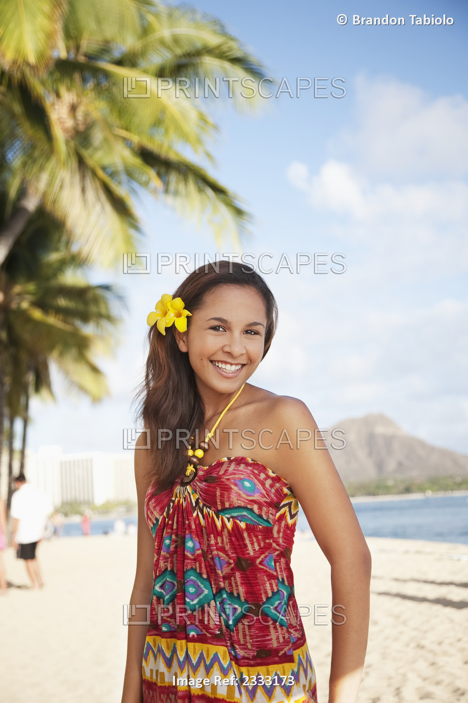 Portrait Of A Woman On A Beach With A Tropical Flower In Her Hair; Waikiki, ...