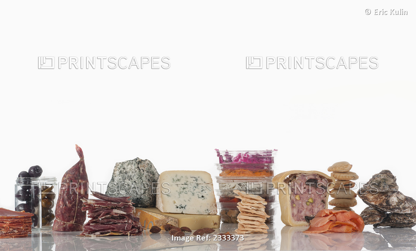 Deli meats and cheeses on a white background