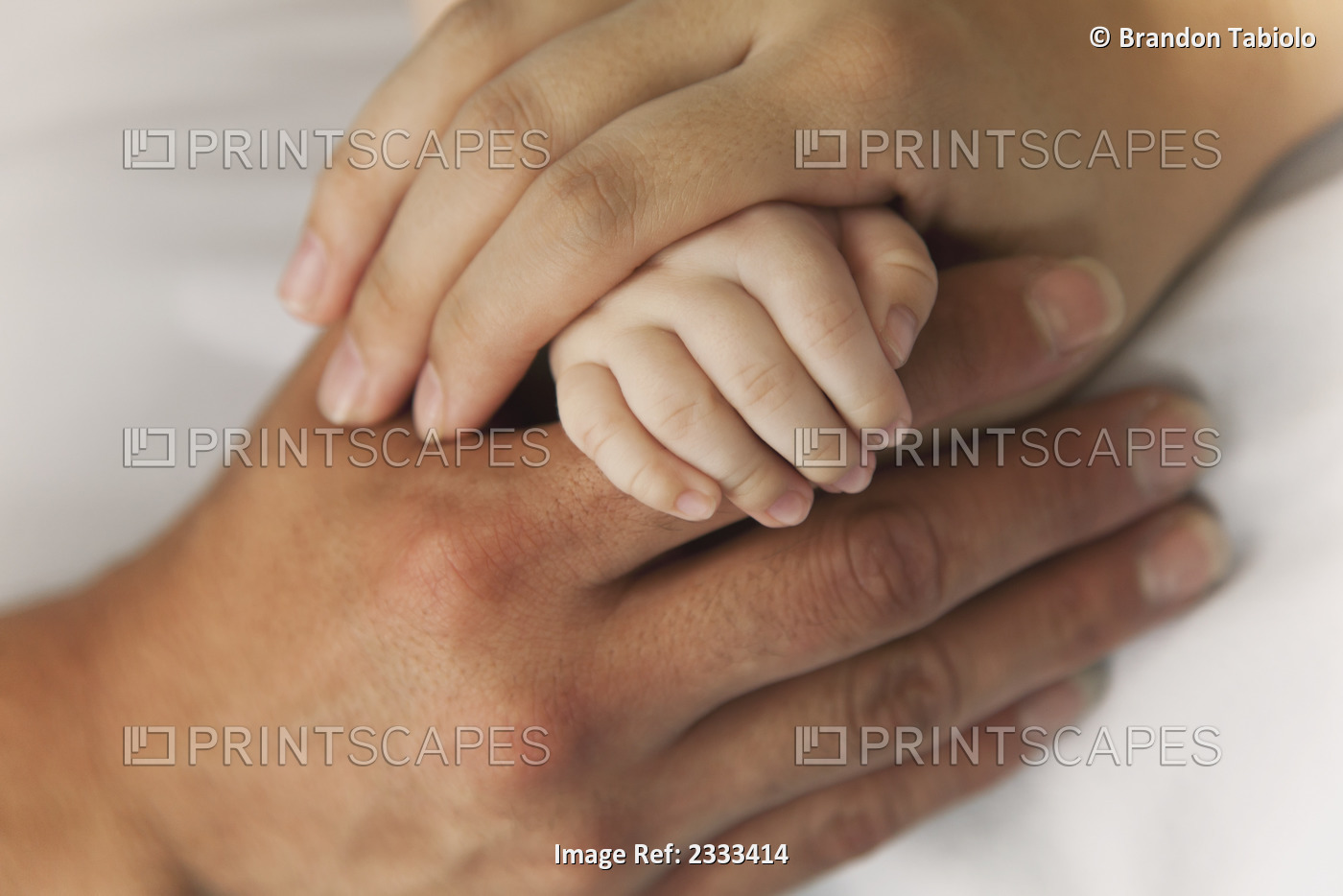 A mother and father's hands holding their baby's hand; Honolulu hawaii united ...