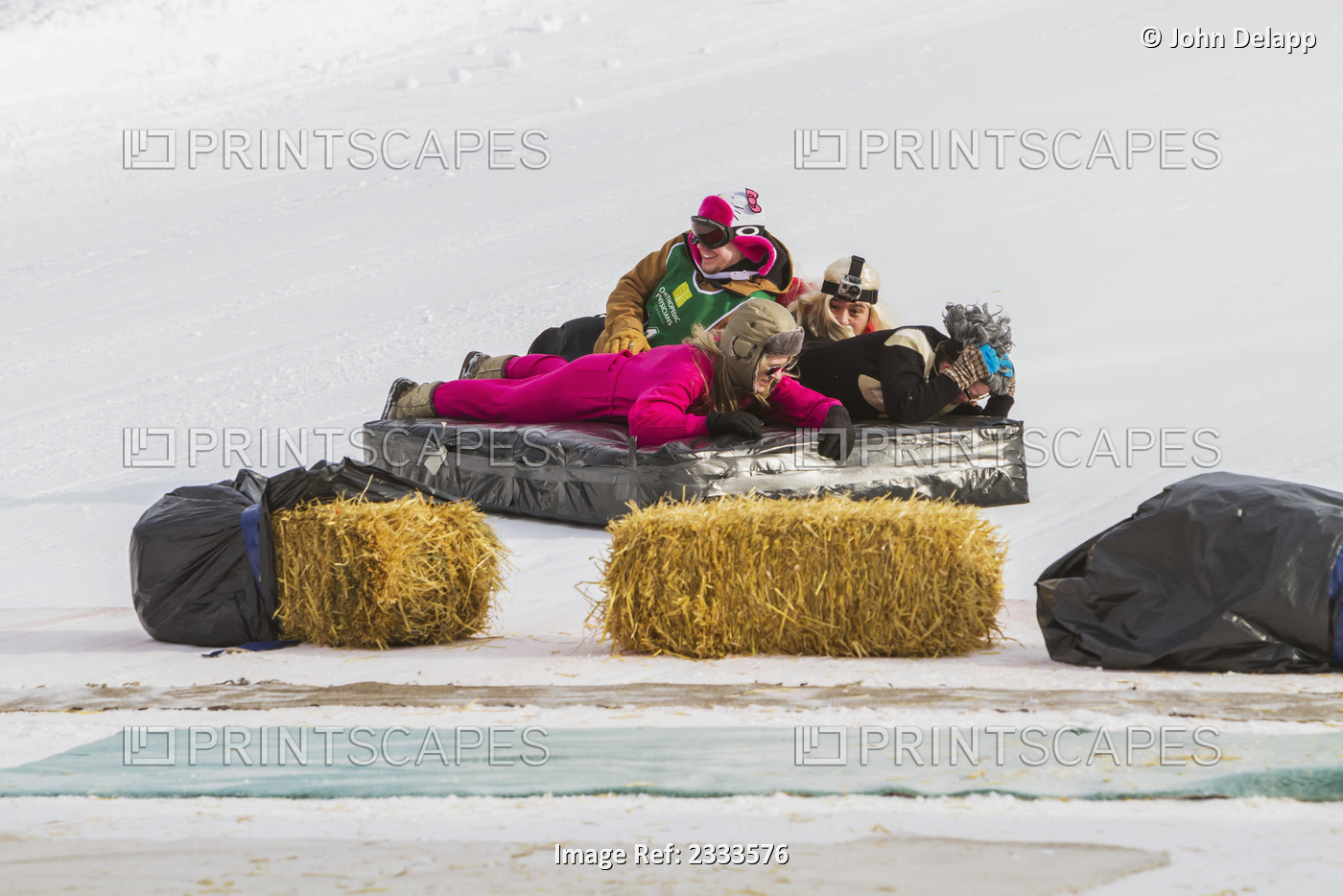 Competitors In The Bed Race Slide Down A Ski Slope And Strike Straw Barriers At ...