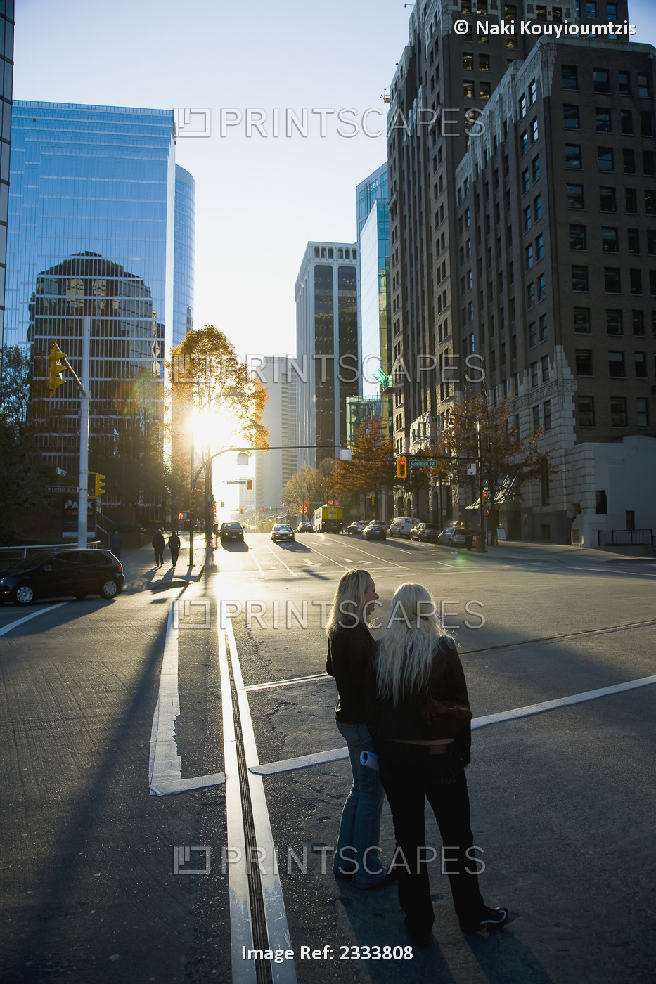 Two Women Standing In Street During Sunset, Downtown; Vancouver, British ...