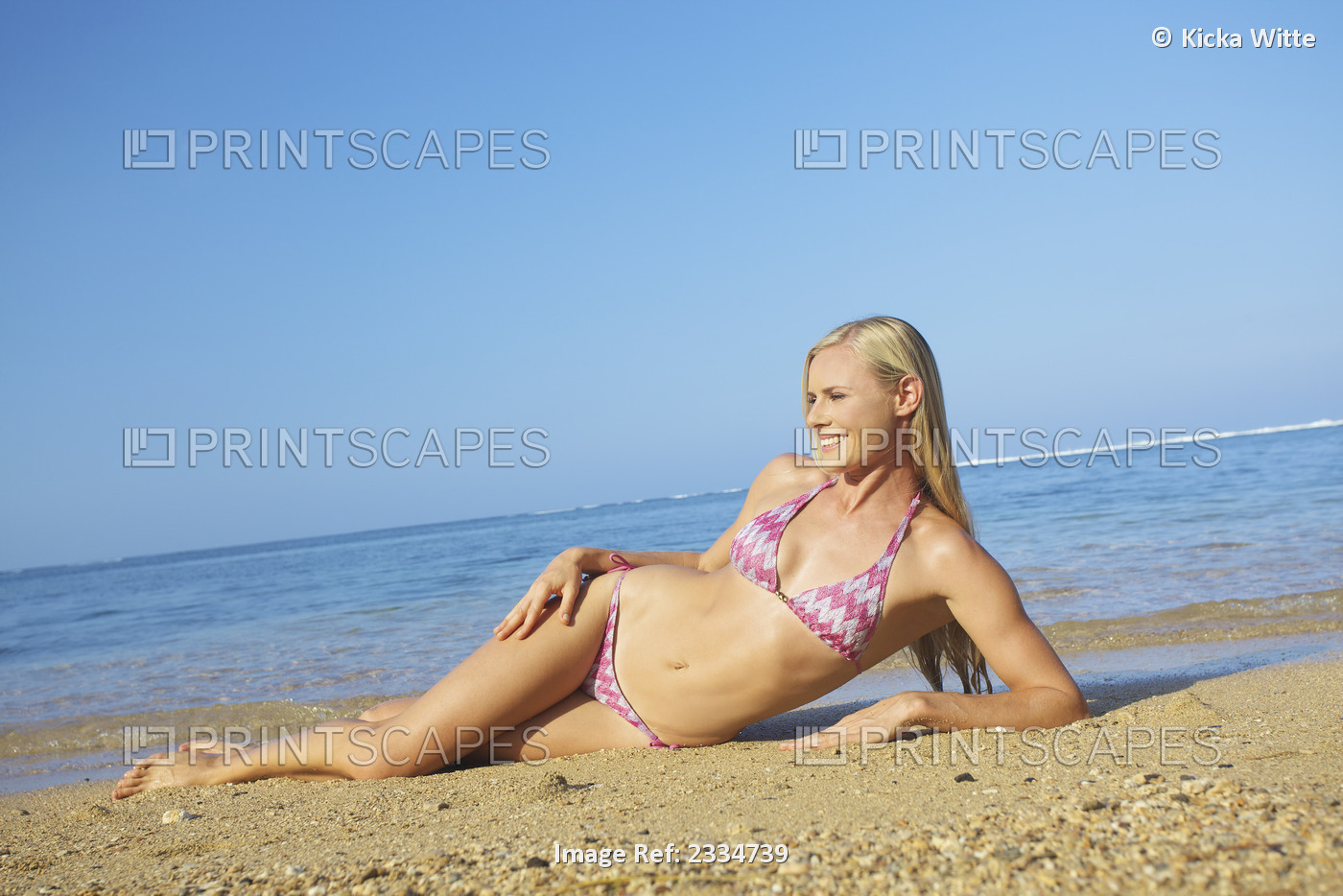 Blond woman in a bikini at the beach; Kauai hawaii united states of america