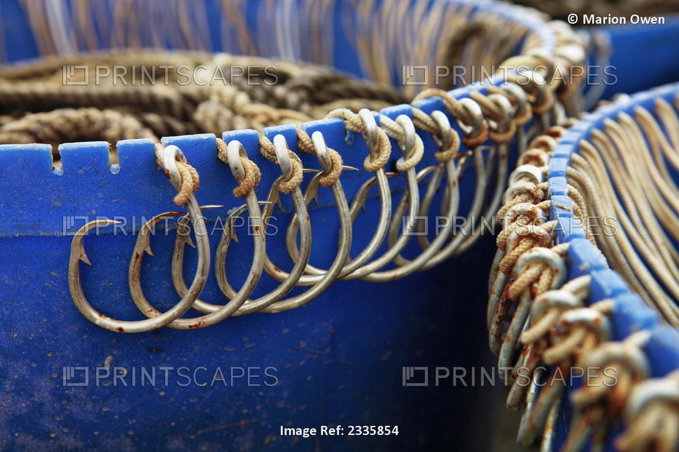 Rusted hooks tied onto a blue edge
