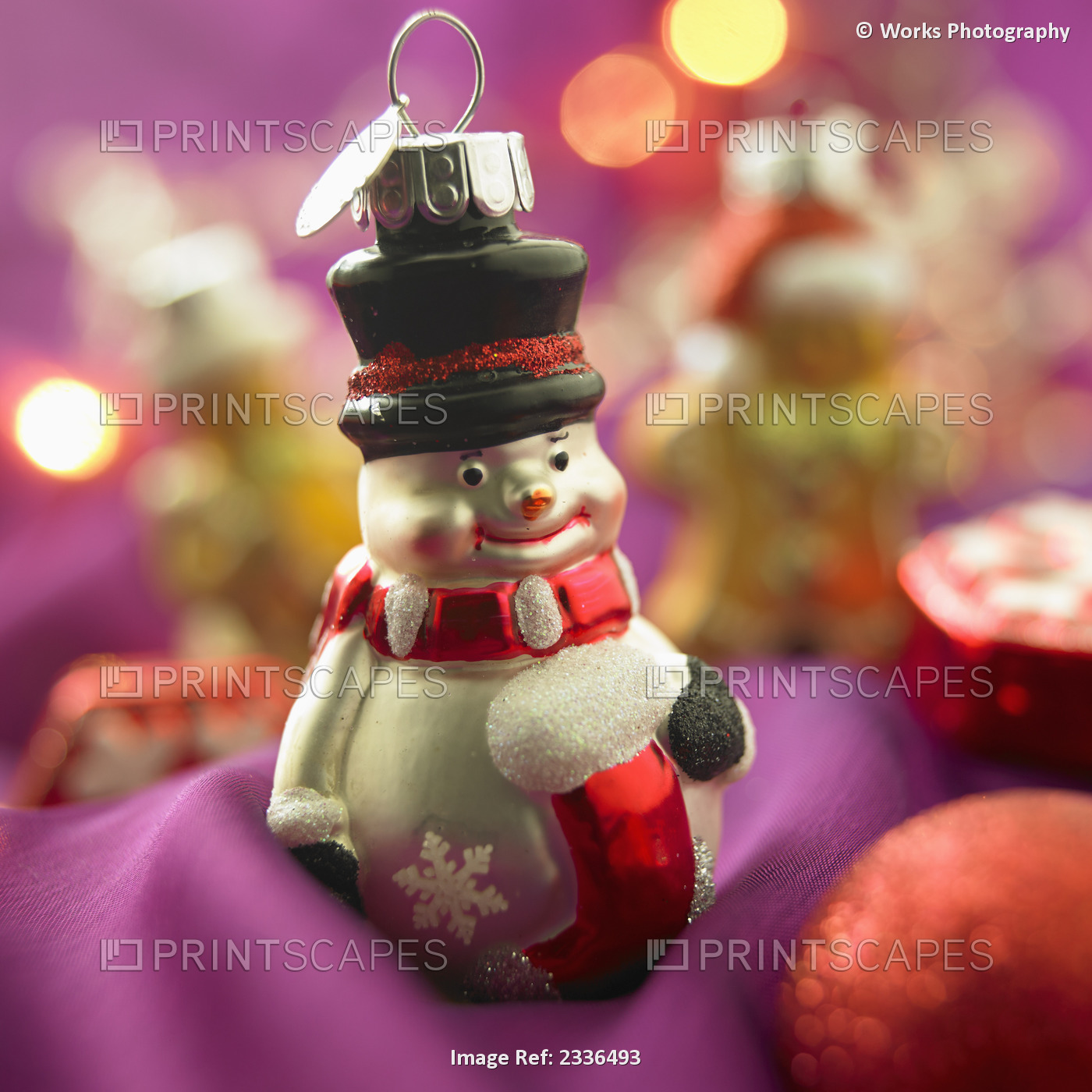 Close-Up Of Snowman Christmas Ornament On Purple Background