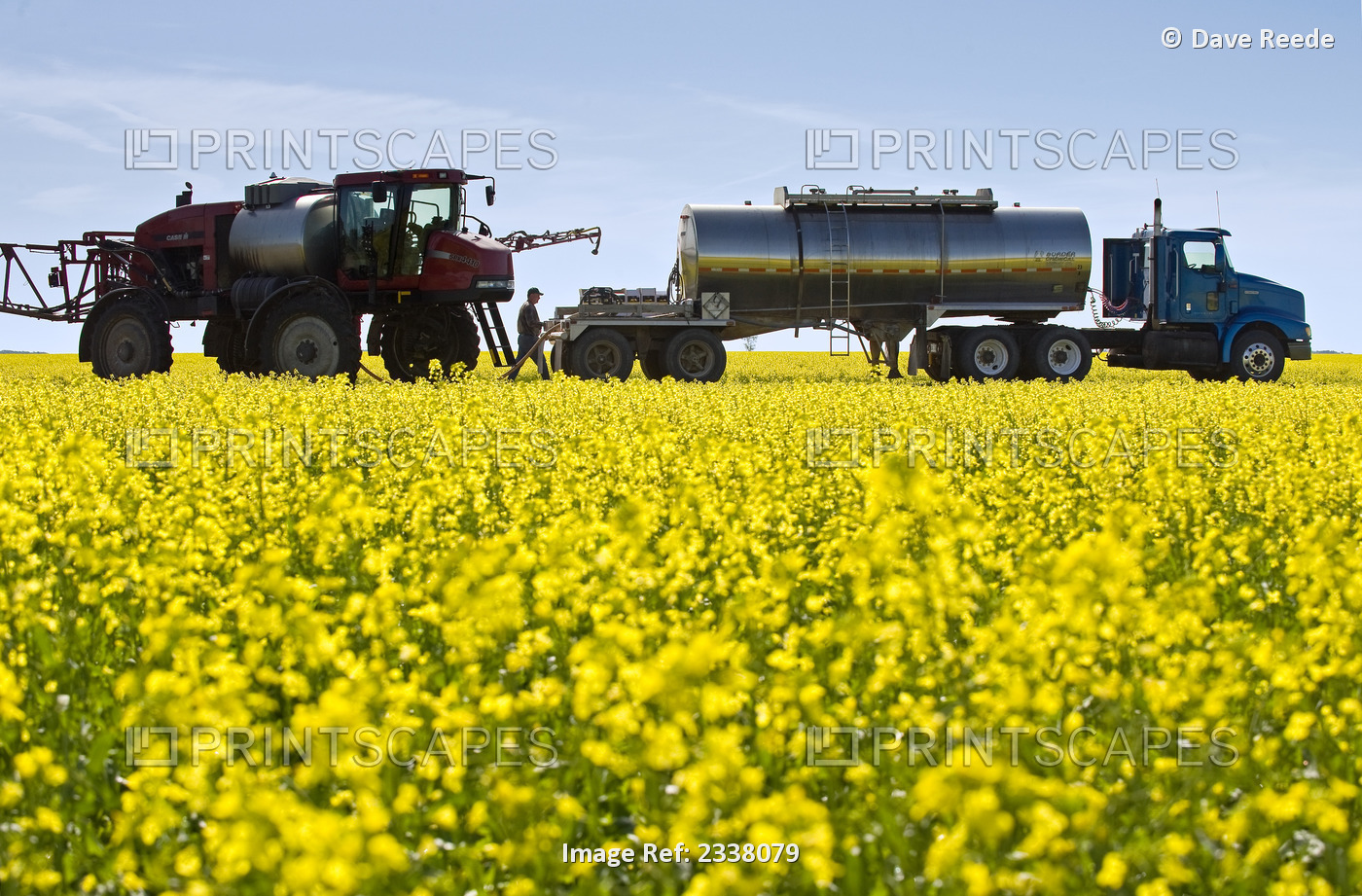 Agriculture - A farmer loads his high clearance sprayer with fungicide and ...