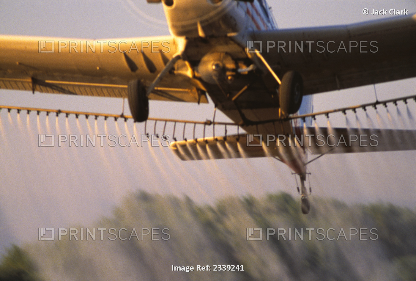 Agriculture - Aerial chemical application, closeup of crop duster as it pulls ...