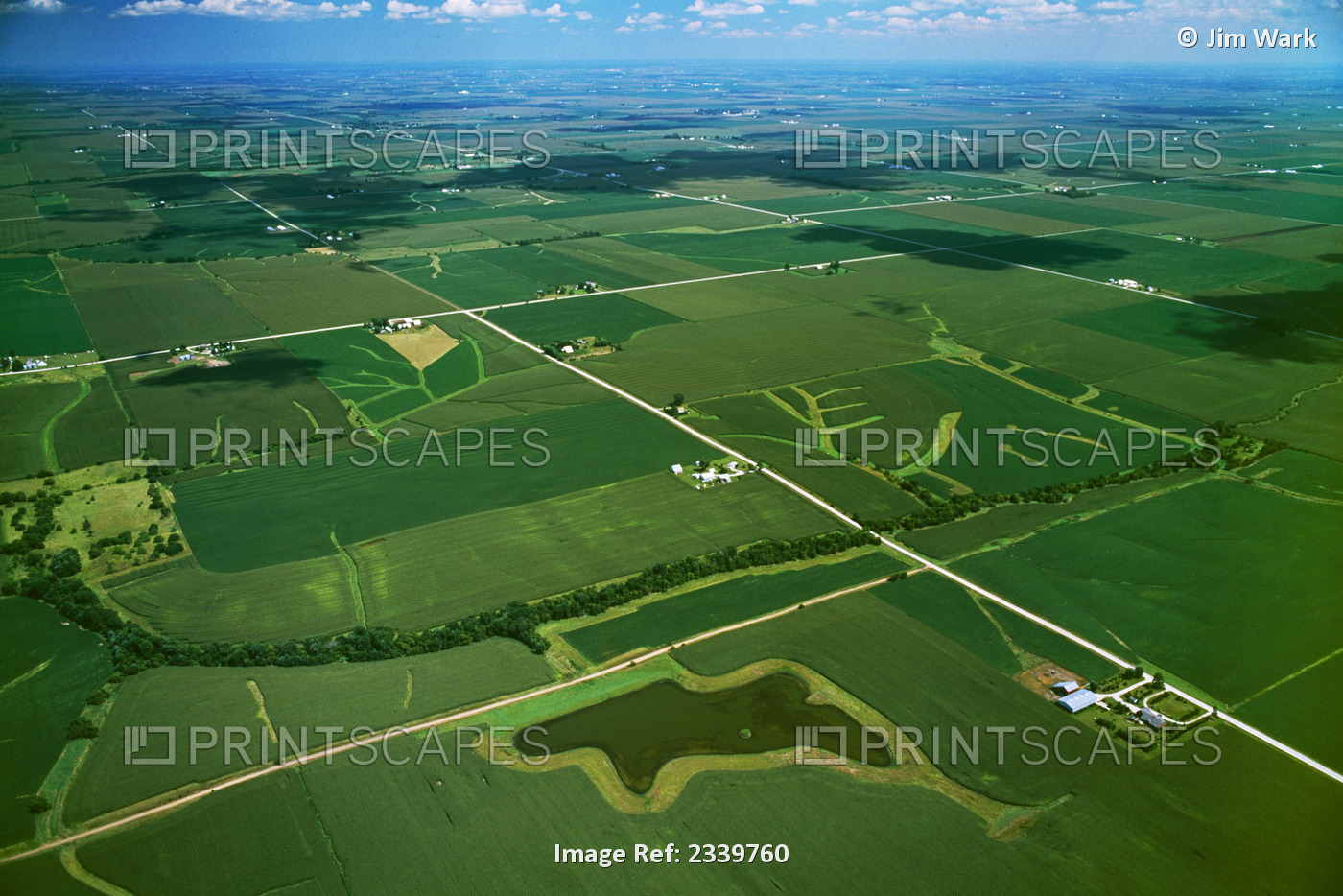Agriculture - Aerial view of farmsteads and agricultural fields with grassy ...