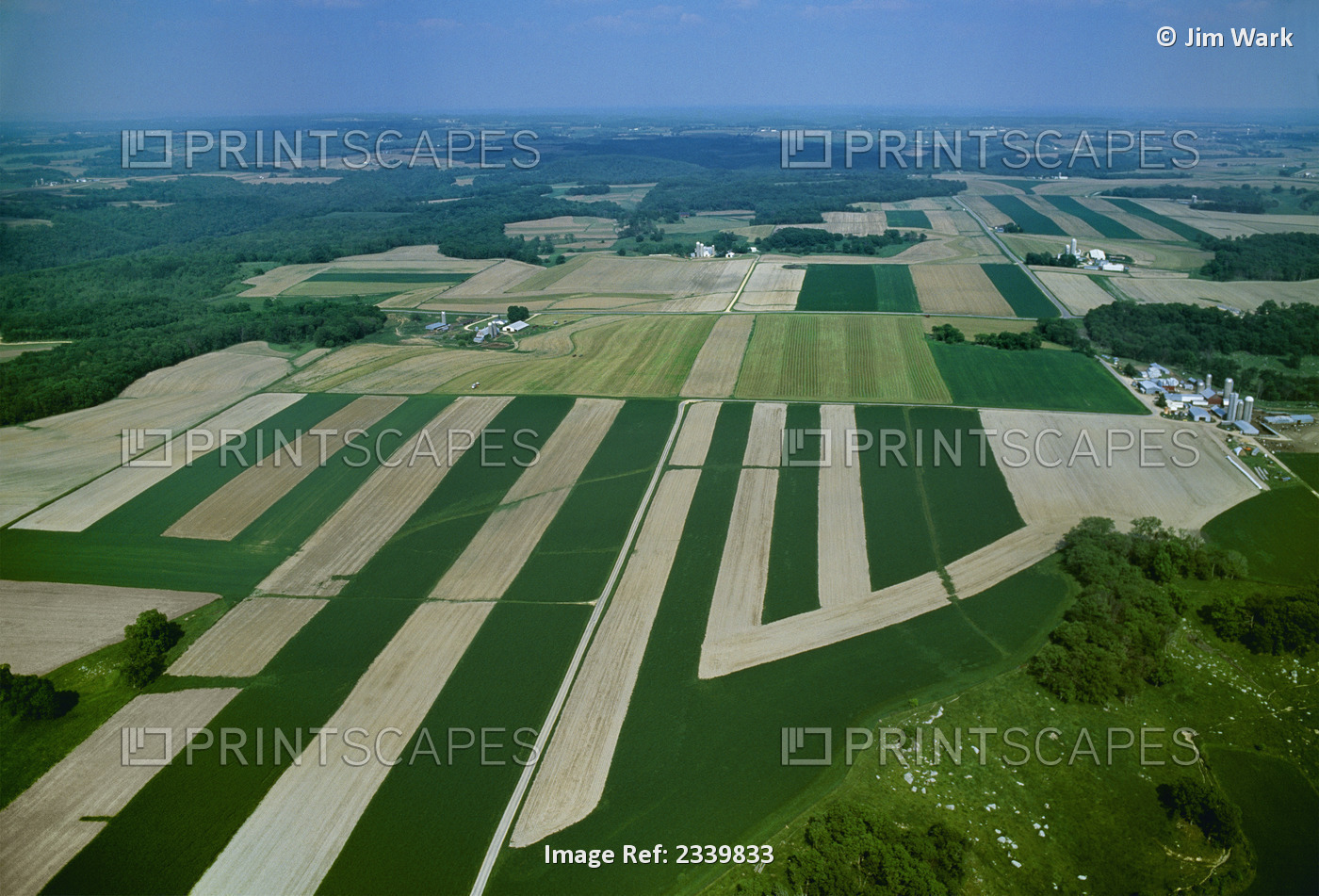 Agriculture - Aerial view of farmsteads and springtime agricultural fields, ...