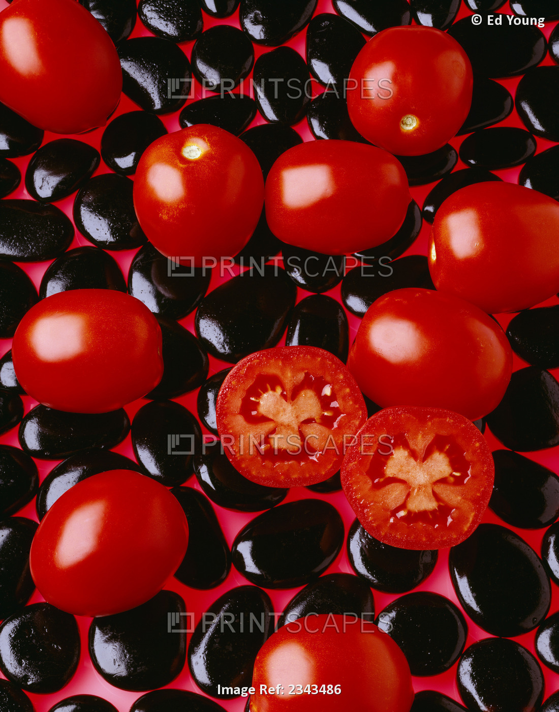 Agriculture - Processing tomatoes on black rocks and red surface, sliced, ...