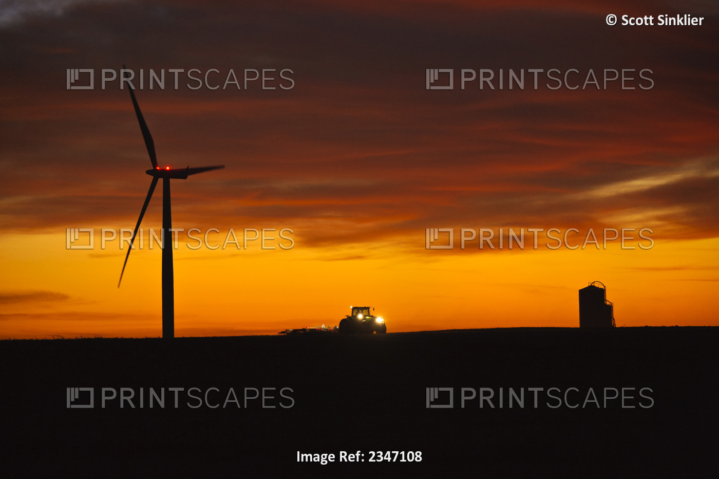 Agriculture - A farmer tills his field at dusk after corn harvest in late ...