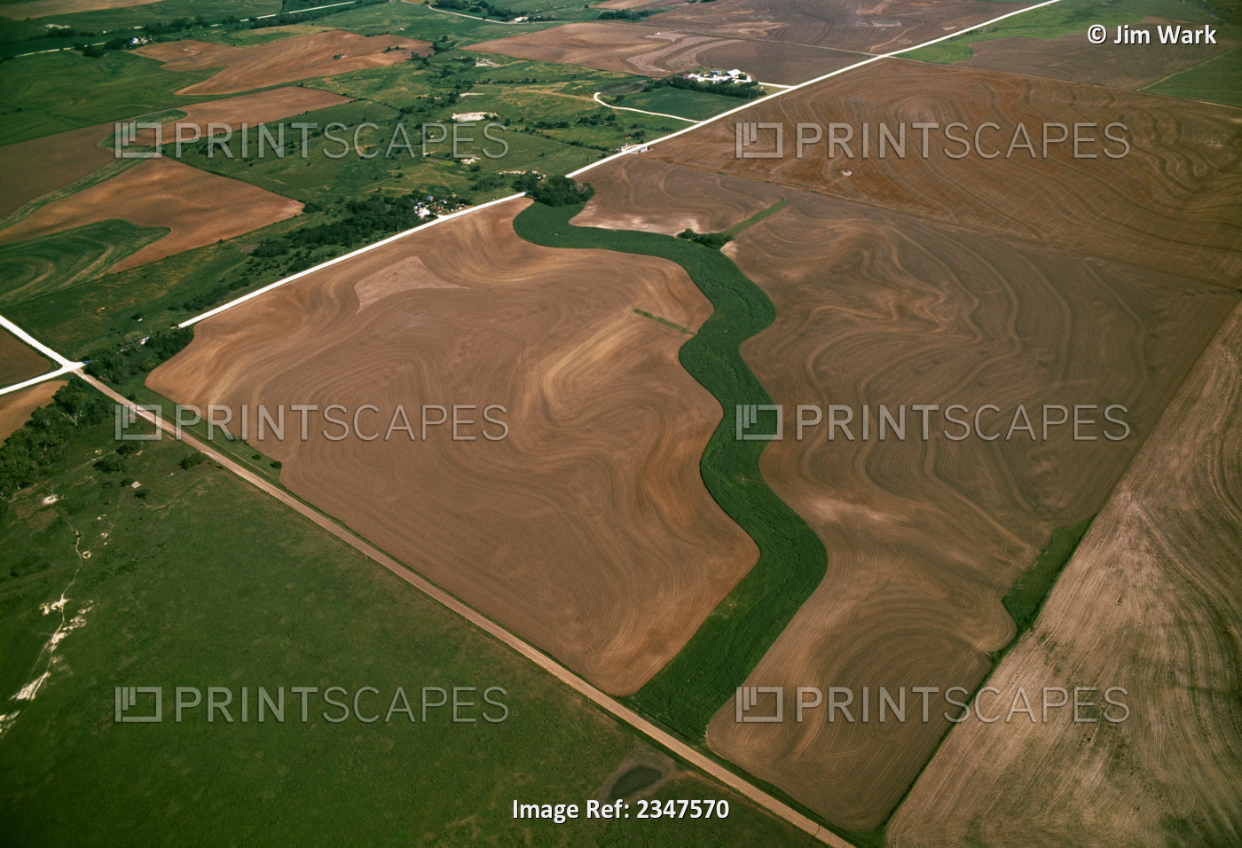 Agriculture - Aerial view of fallow agricultural land with a grassy waterway ...