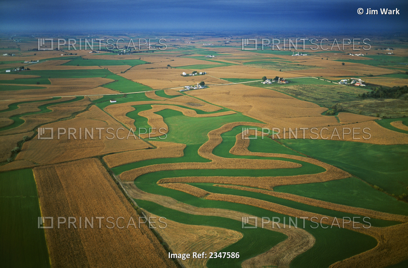 Agriculture - Aerial view of farmsteads and contoured corn and alfalfa fields / ...