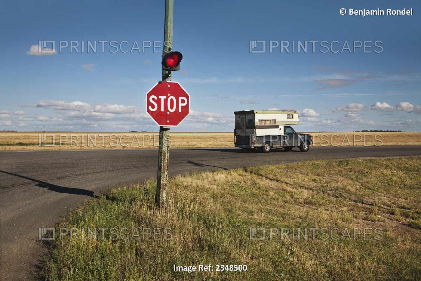 A Stop Sign And Red Light At An Intersection; Saskatchewan, Canada