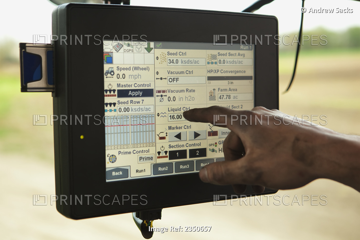 Agriculture - A farmer uses a touch screen computer mounted in his tractor's ...