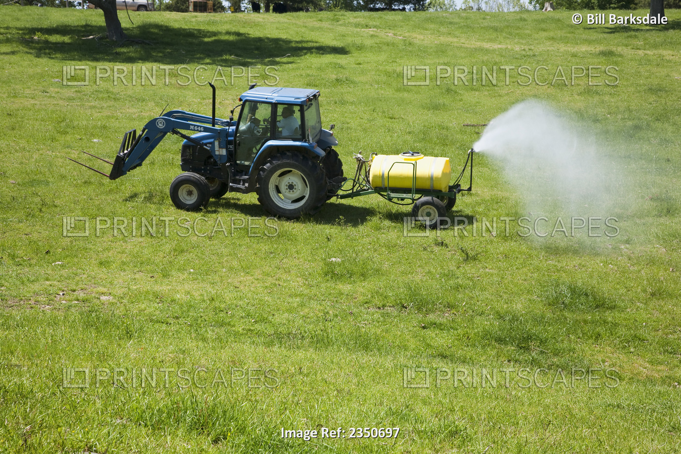 Agriculture - Spraying herbicide on a pasture used for grazing beef cattle. The ...